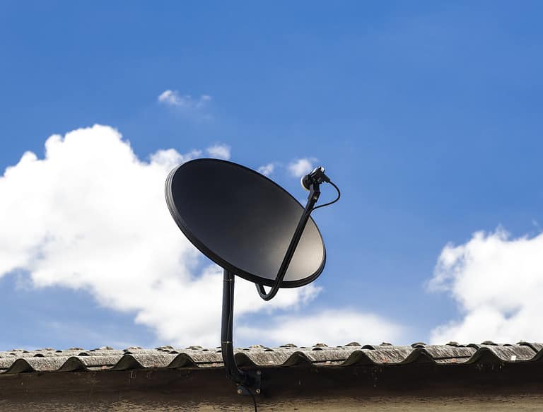 A satellite dish mounted on a wall