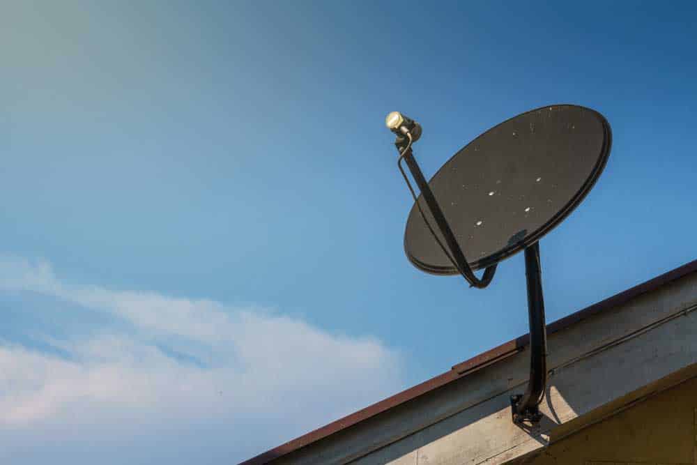 Satellite dish mounted on a roof fascia