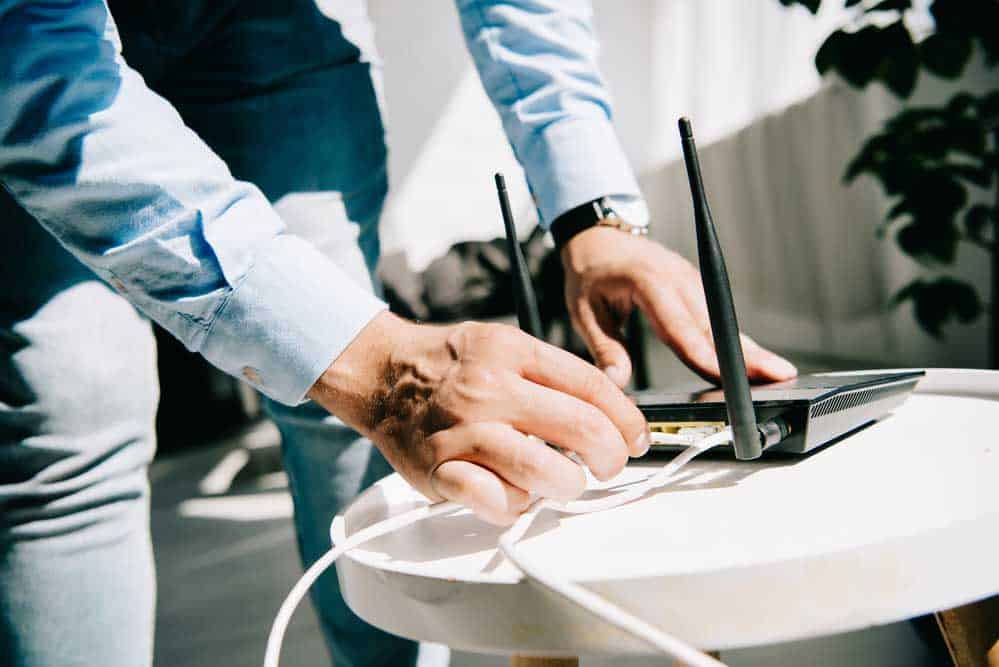 Man successfully connects Ethernet cable to a router