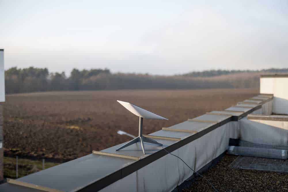 Starlink dish on the roof with a clear background