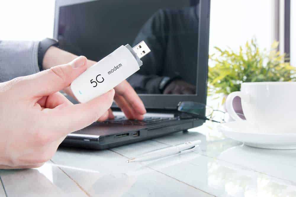 Man holding 5G USB modem