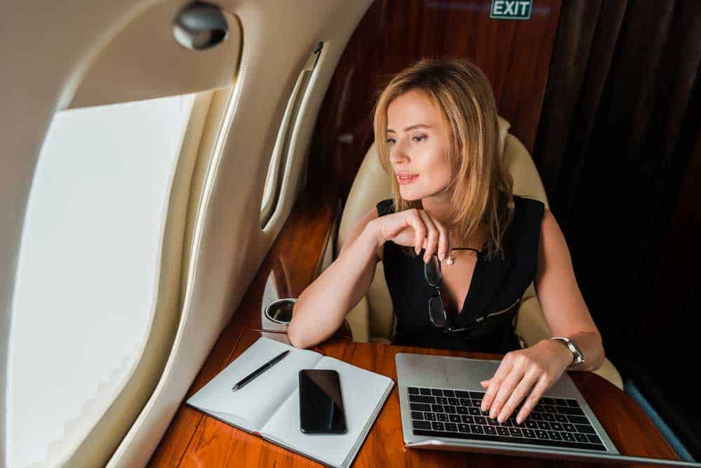 A woman uses the internet on board a plane