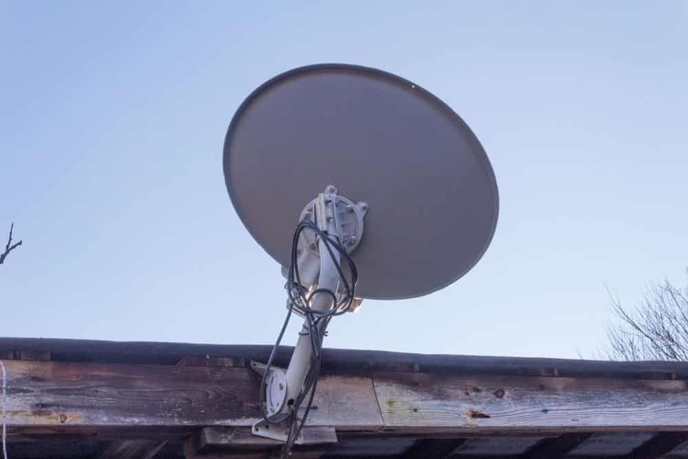 Satellite dish mount on the eave of a roof