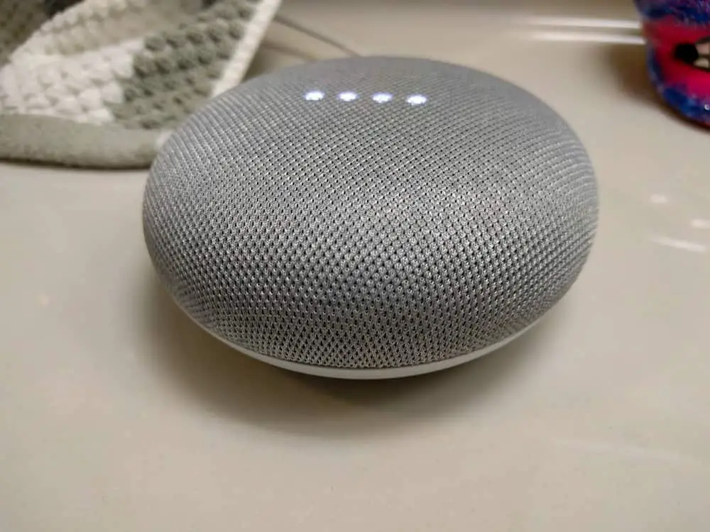 A smart speaker on a counter with LED light activated
